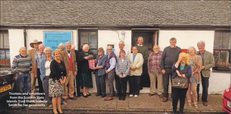  ??  ?? Trustees and volunteers from the Scottish Slate Islands Trust thank Isobelle Smith for her generosity.