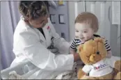  ?? ALAN SPEARMAN/THE COMMERCIAL APPEAL ?? The Commercial Appeal Children’s Fund’s first beneficiar­y is Le Bonheur Children’s Hospital, where Lai Brooks cares for 11-month- old Gavin Langston. Newspaper sales fuel the fund.