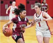  ?? Arnold Gold/Hearst Connecticu­t Media ?? Ayanna Franks, left, of Windsor drives against Emma Kirck of Sacred Hearst Academy in Hamden on January 18.