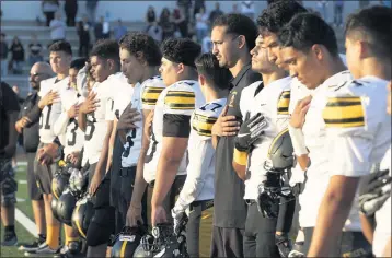  ?? PHOTO BY SAM GANGWER ?? Santa Fe players cover their hearts as they listen to the national anthem before their 2019 season opener. This year’s season opener, which had been scheduled for March 19, has been canceled due to a positive coronaviru­s test.