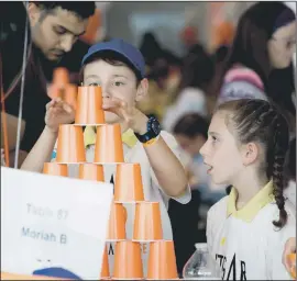  ??  ?? Left: Kerem contestant­s with Chief Rabbi Ephraim Mirvis (top left), who attended with Sephardi leader Rabbi Joseph Dweck and Israel Ambassador Mark Regev. Above: Moriah students complete the pyramid challenge — each cup represents something in Judaism with a numerical link and the children had to stack the cups in the right rows