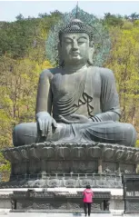  ??  ?? A Buddha shrine gazes serenely out over Seoraksan National Park.