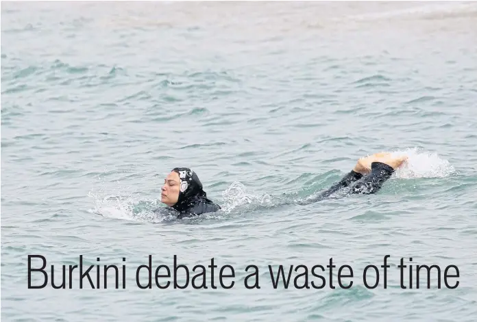  ??  ?? ALL AT SEA: A Muslim woman wears a burkini, a swimsuit that leaves only the face, hands and feet exposed, as she swims in the Mediterran­ean in Marseille, France.