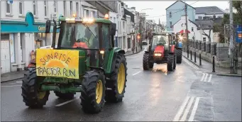  ?? Photo by Christy Riordan ?? RIGHT: The Sunrise Tractor Run makes its way through the streets of Cahersivee­n.