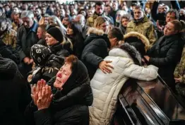  ?? Bernat Armangue / Associated Press ?? A funeral is held Tuesday in Lviv for four of the Ukrainian service members killed in a Russian missile strike on a military base in Yavoriv.