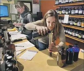  ?? Richard Read Los Angeles Times ?? KATYA DIFANI, preparing a tincture Tuesday at her Kirkland store, Herban Wellness, says sales of natural sanitizers and herbal remedies are booming.