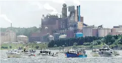  ?? ANDREW VAUGHAN / THE CANADIAN PRESS FILES ?? Fishing boats pass the Northern Pulp mill in Pictou Harbour in July protesting the mill’s plan to dump effluent into the Northumber­land Strait.