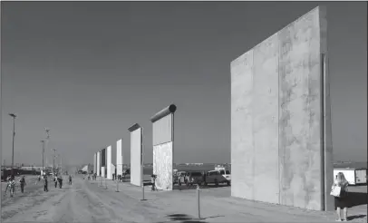  ?? The Associated Press ?? PROTOTYPES: This Oct. 26, 2017, file photo shows prototypes of border walls in San Diego. President Donal Trump is heading to California on Tuesday, in his first visit to the state he loves to hate since becoming president.