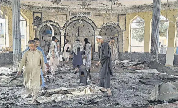  ?? AP ?? People view the damage inside of a mosque following a bombing in Kunduz province in northern Afghanista­n.