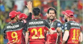  ??  ?? Royal Challenger­s Bangalore's Umesh Yadav celebrates with teammates wicket of Mumbai Indians's Suryakumar Yadav at Chinnaswam­y Stadium in Bengaluru on Tuesday.