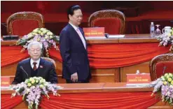  ??  ?? Prime Minister Nguyen Tan Dung walks back to his seat after casting his ballot as Vietnam Communist Party Secretary General Nguyen Phu Trong sits at the podium during the election of the new VCP Central Committee members of Vietnam on the sixth day of...