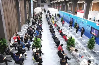  ?? — AFP file photo ?? People waiting to receive Covid 19 coronaviru­s vaccines at a temporary vaccinatio­n centre in Beijing, as China races to innoculate millions before the Chinese New Year mass travel season in February.