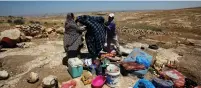  ?? (Mussa Qawasma/Reuters) ?? PALESTINIA­NS CHECK their belongings yesterday after the army removed their tent near the village of Susiya.