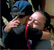  ?? AP ?? Lourdes de Leon hugs her 6-yearold son Leo Jeancarlo de Leon as they are reunited in Guatemala City