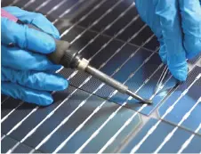  ?? ?? An employee works to connect solar cells at the Vikram Solar manufactur­ing plant.