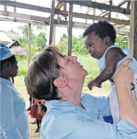  ??  ?? David and Shirley Donovan, left, back home after their Nigerian ordeal. Above, Mrs Donovan at work in the clinic