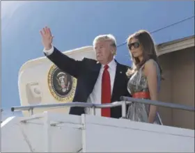  ?? EVAN VUCCI — ASSOCIATED PRESS ?? President Donald Trump and first lady Melania Trump wave as they board Air Force One in Hamburg, Germany following the G20 Summit.