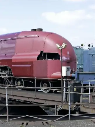  ?? BOB MEANLEY ?? LMS history recreated and a tantalisin­g glimpse of what was to come on May 7 2009 as ‘Hamilton’ is shunted into the paintshop at Tyseley. Unveiling in York is just 12 days away.