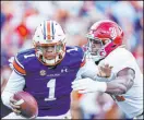  ?? The Associated Press ?? Butch Dill
Auburn quarterbac­k TJ Finley tries to avoid Alabama’s Will Anderson Jr. during the Iron Bowl rivalry game on Nov. 27.