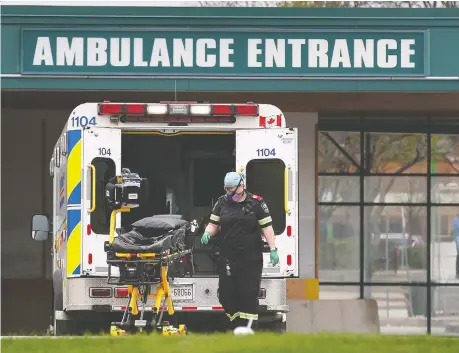  ?? DAN JANISSE ?? A paramedic loads a stretcher on Friday at the Windsor Regional Hospital Met Campus. Windsor is transporti­ng stable COVID-19 patients from Toronto to be cared for locally, although it is not disclosing which Toronto hospitals the patients are from.