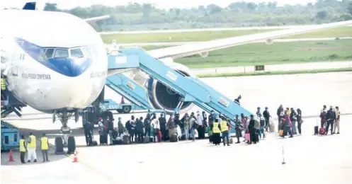  ?? PHOTO: ?? A cross section of 268 Nigerians stranded in China, on arrival at the Nnamdi zikiwe Internatio­nal Airport, Abuja, on Saturday. They proceeded for the mandatory 14-day quarantine by the Nigeria Centre for Disease Control. NAN