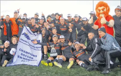  ?? DAVID JALA/CAPE BRETON POST ?? Players, coaches and mascot gather for an impromptu pictures minutes after the Cape Breton Capers won their second consecutiv­e Atlantic University Sports men’s soccer championsh­ip. The Capers defeated the University of New Brunswick Varsity Reds 1-0 to...