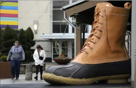  ?? GENE J. PUSKAR — THE ASSOCIATED PRESS ?? Shoppers pass a large L.L. Bean boot displayed outside an L.L. Bean store in Pittsburgh on Jan. 30. On Wednesday, the Commerce Department releases U.S. retail sales data for January.