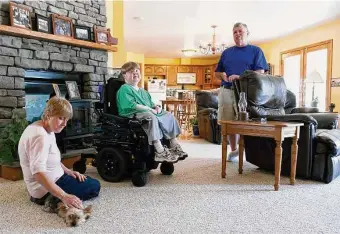  ?? Kate Collins/Associated Press ?? Terry Horgan with his parents in the family’s Montour Falls, N.Y., home. Horgan, 27, who had Duchenne muscular dystrophy, died last month, according to the nonprofit founded to save him.