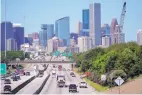  ?? DAVID J. PHILLIP/ASSOCIATED PRESS ?? Traffic moves along Interstate 10 near downtown Houston. Like in other cities, the coronaviru­s has shut down much of Houston’s economic activity, slashing thousands of jobs.