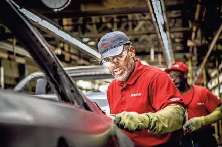  ?? NISSAN ?? A Nissan manufactur­ing team member works on the assembly line at the plant in Smyrna.