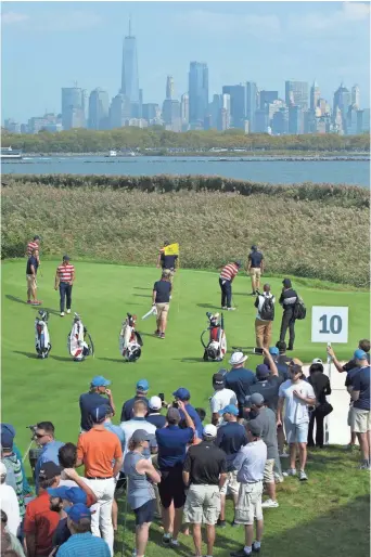  ?? BILL STREICHER, USA TODAY SPORTS ?? Fans watch U.S. team golfers on the 10th hole Tuesday at Liberty National Golf Club, which is hosting The Presidents Cup competitio­n this week. The course is less than 1,000 yards from the Statue of Liberty.