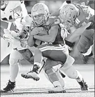  ?? AP/GAIL BURTON ?? Navy quarterbac­k Malcolm Perry carries against Virginia in the first half of the Military Bowl on Thursday in Annapolis, Md. Perry had 114 yards rushing and two touchdowns to help lead Navy to a 49-7 victory.