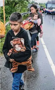  ?? Associated Press file photo ?? Migrants are taken off a bus last month at a checkpoint in El Cinchado, Guatemala.