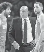  ?? Kyusung Gong Associated Press ?? COACH DOC RIVERS talks with Milos Teodosic, left, and Austin Rivers during a game this month.