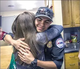  ??  ?? With a pie in hand, Gabriela Park hugs a station firefighte­r.