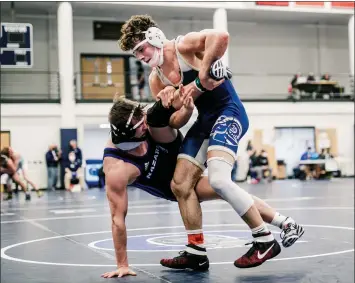  ?? NATE HECKENBERG­ER - FOR MEDIANEWS GROUP ?? Spring-Ford’s Joey Milano takes Nazareth’s Drew Clearie to the mat en route to a 5-2 win in the 189-pound semifinal.