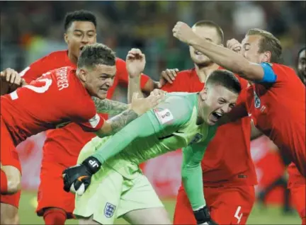  ?? VICTOR R. CAIVANO — THE ASSOCIATED PRESS ?? England’s Harry Kane, right, goalkeeper Jordan Pickford, centre, and Kieran Trippier celebrate with teammates at the end of the round of 16 match between Colombia and England. England won after a penalty shoot out.