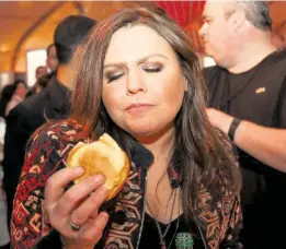  ?? MATIAS J. OCNER Miami Herald file ?? Rachael Ray enjoys Rob Goodman’s burger during the Burger Bash on Feb. 26, 2016.