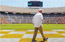  ?? STAFF PHOTO BY C.B. SCHMELTER ?? Tennessee coach Jeremy Pruitt walks on the field before the Orange and White Game on Saturday at Neyland Stadium. Pruitt said coaches will meet individual­ly with players to discuss spring performanc­e.