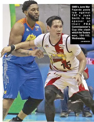  ?? JUN MENDOZA ?? SMB’s June Mar Fajardo posts low against TNT’s Josh Smith in the opener of their PBA Commission­er’s Cup title clash which the Texters won, 104-102, Wednesday.