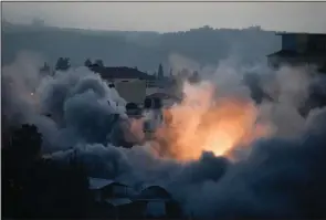  ?? (AP Photo/Majdi Mohammed) ?? Israeli troops blow up the house of Palestinia­n militant Diaa Hamarsheh on Thursday in the West Bank village of Yabed.