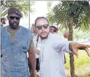  ?? NETFLIX ?? Director Cary Joji Fukunaga, an Oakland native, works with actor Idris Elba during the filming of “Beasts of No Nation.”