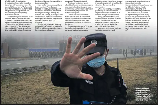  ?? Photo / AP ?? A security guard moves journalist­s away from the Wuhan Institute of Virology after a WHO team arrived for a field visit.