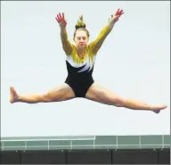  ?? Christian Abraham / Christian Abraham ?? Jonathan Law’s Melanie Coleman competes on the balance beam during a competitio­n in 2015 against Foran in Milford.