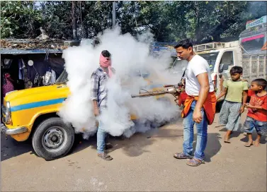  ?? REUTERS ?? A taxi driver covers his face as a municipal worker fumigates a market to prevent the spread of dengue fever and other mosquitobo­rne diseases in Kolkata, on Monday.
