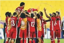  ?? AFP ?? Al Jazira players celebrate a goal during the AFC Champions League match against Al Gharafain Doha on Tuesday.