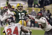  ?? MIKE ROEMER — THE ASSOCIATED PRESS ?? Green Bay Packers quarterbac­k and Chico native Aaron Rodgers (12) evades a tackle as he looks to pass against the Tampa Bay Buccaneers during the second half of the NFC championsh­ip game in Green Bay, Wis., on Sunday.