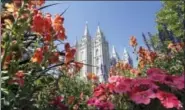  ?? RICK BOWMER-THE ASSOCIATED PRESS ?? Flowers bloom in front of the Salt Lake Temple, at Temple Square, in Salt Lake City. Mormons will hear guidance and inspiratio­n from the religion’s top leaders during a church conference this weekend in Salt Lake City as well as getting an update about...