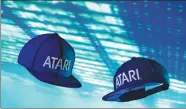  ?? TNS ?? A new product of Atari, a baseball-style cap, comes with its own stereo speakers inside the bill of the cap.