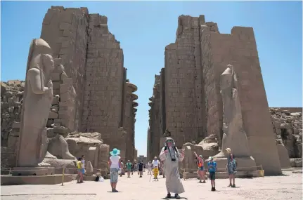  ?? Hassan Ammar / AP Photo ?? Tourists at the ancient temple of Luxor in June, days after a failed terror attempt when a suicide bomber blew himself up.